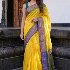 manjal yellow mul cotton saree features a contrasting purple border with green accents