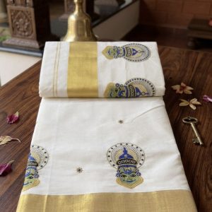 kathakali white cotton kerala saree features a distinctive gold zari border and intricate kathakali face embroidery.