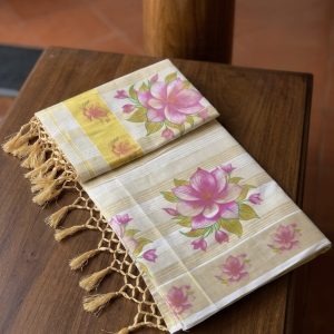 kamala tissue set saree features a pink lotus floral print and a golden zari border